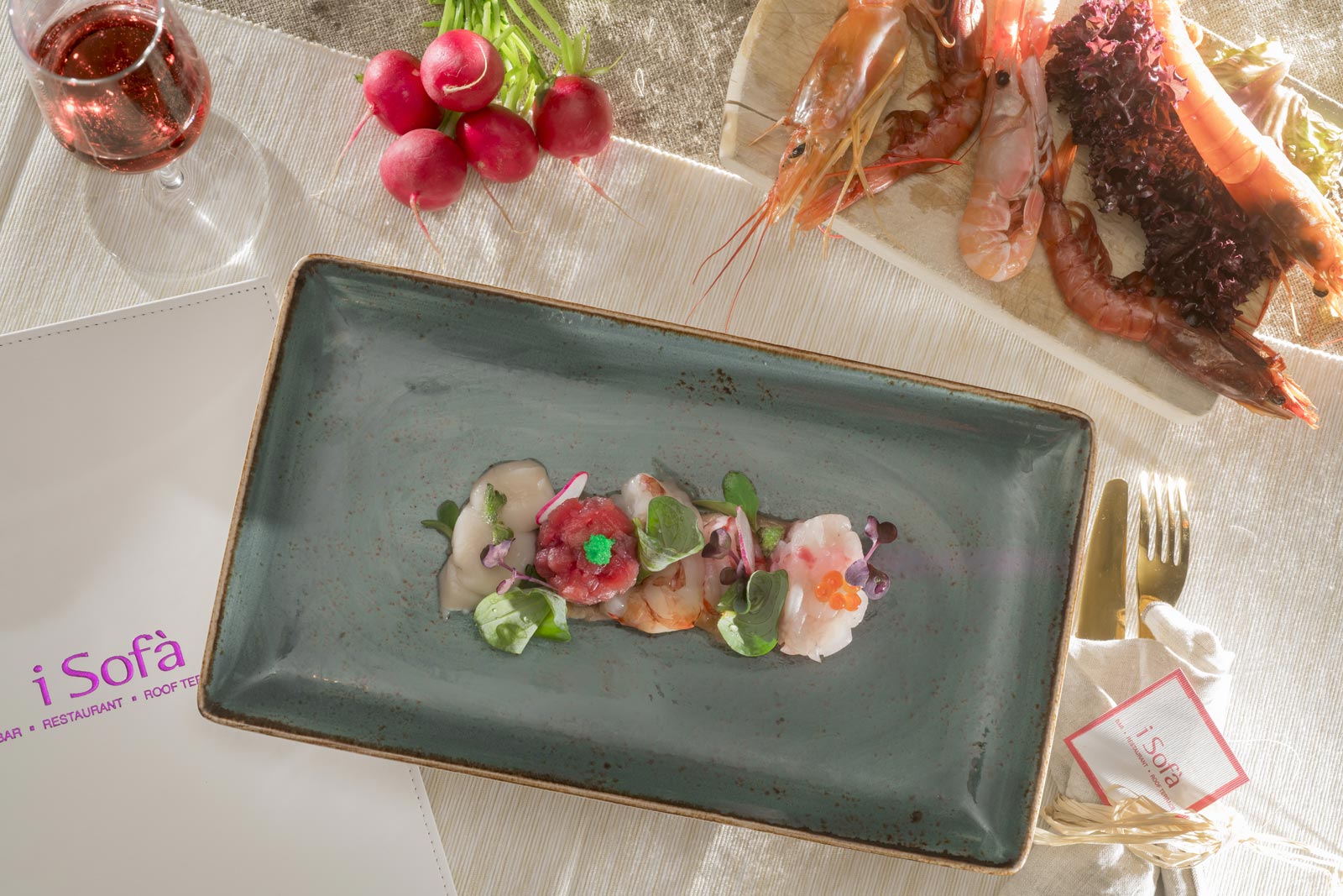 Raw seafood mirror with diced salmon, scallop carpaccio, red prawn (*) Norway lobster (*), tartare of sea bass, tartare of tuna and white prawn with radish chips, oyster leaf, wasabi eggs and salmon eggs