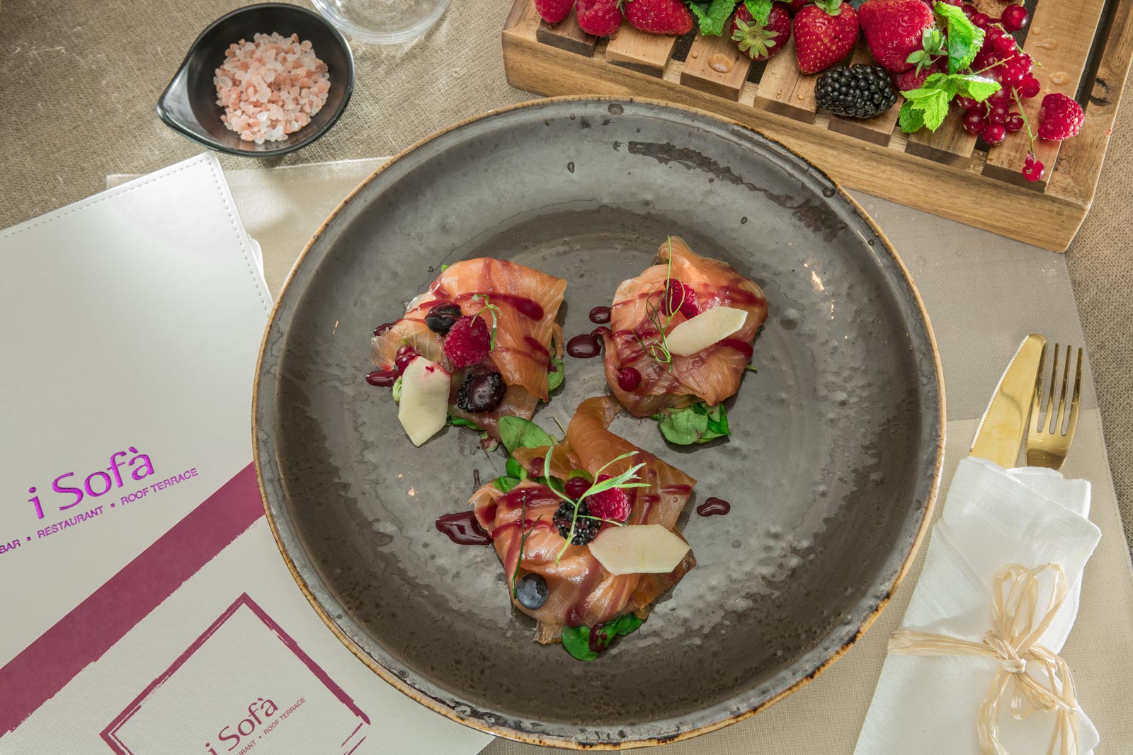 Gin & tonic salmon with beetroot and a raspberry and lime sauce on a green apple and red fruit salad